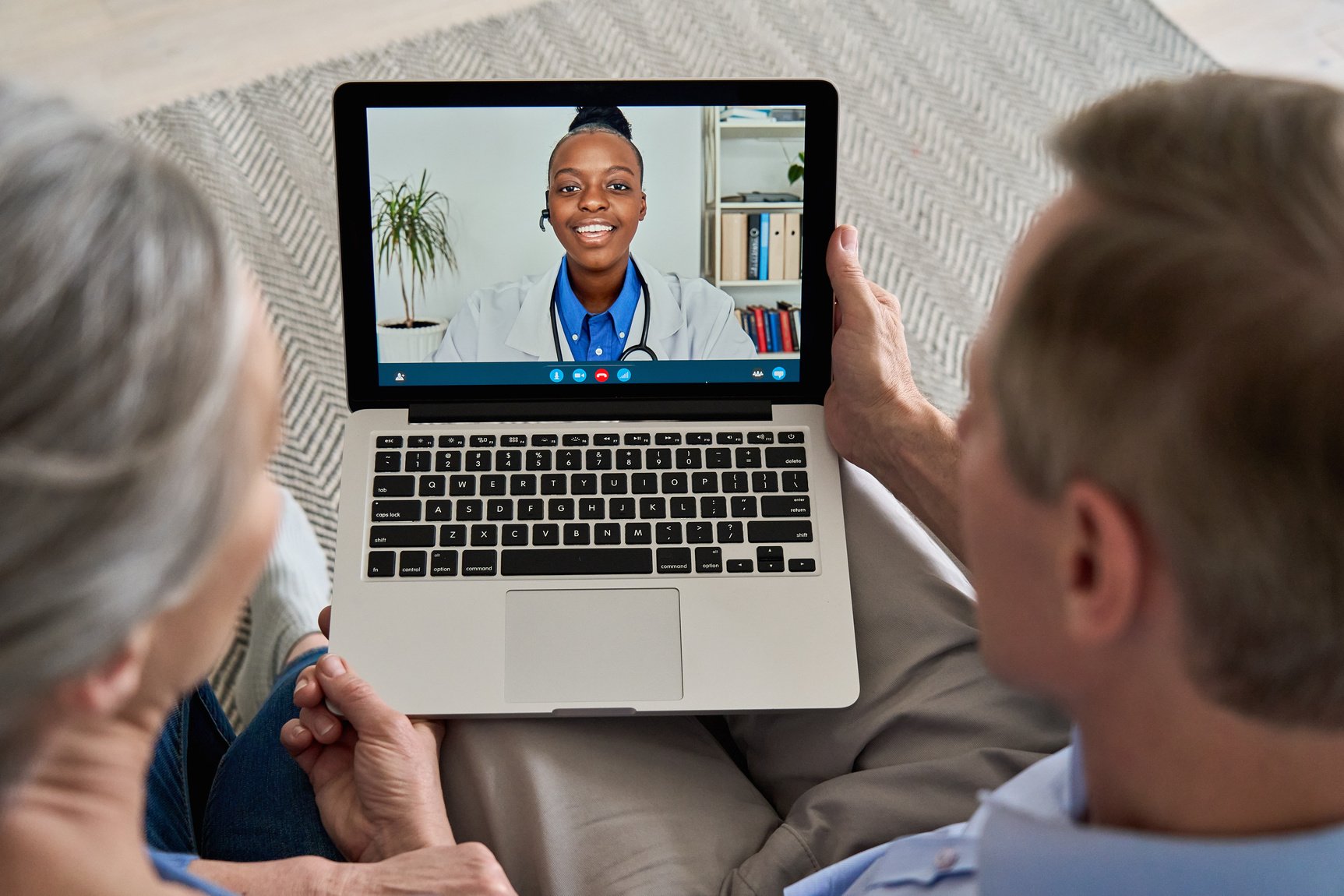 Elderly Couple Talking to a Virtual Doctor on a Laptop